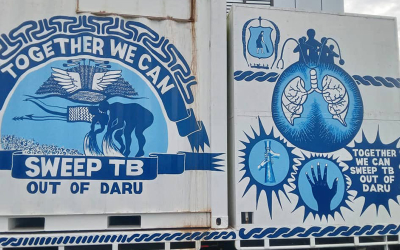 A van with a blue mural picturing lungs, silhouettes of people and 'Together we can SWEEP TB Out of Daru'