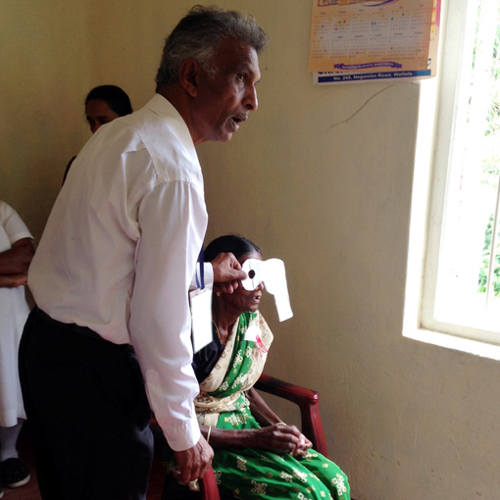 A woman is screened by an eye health promoter