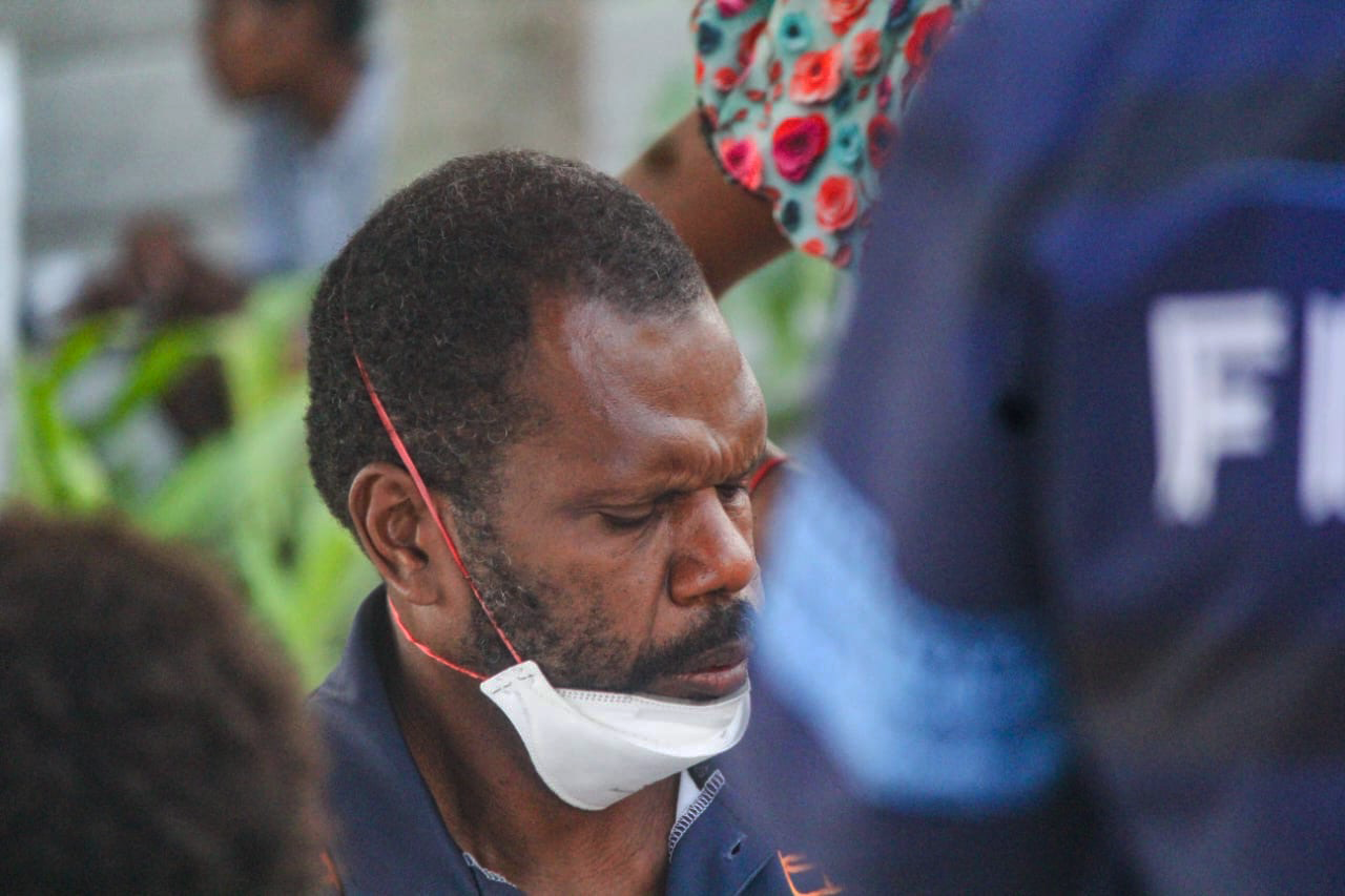 Close on nurse Sakaiah Luana, taking a breath during community screening.