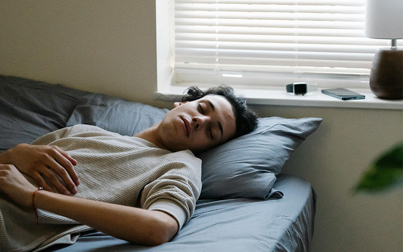 Man sleeping on a bed.