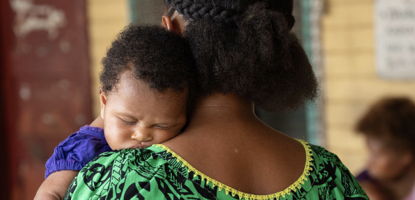 A mother and child attend the Paparatava Health Centre in East New Britain, Papua New Guinea