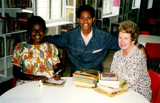 Liven, a teacher, and Margery Nash in a library.
