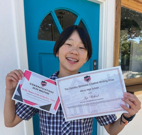 Jojo with her award certificates.