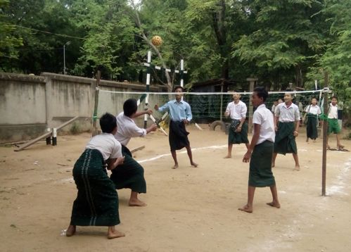 Schoolgirls playing volleyball