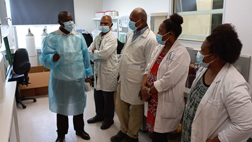 Image: Microbiology Officer Dr Victor Musyoki (left) with the Port Moresby lab team.
