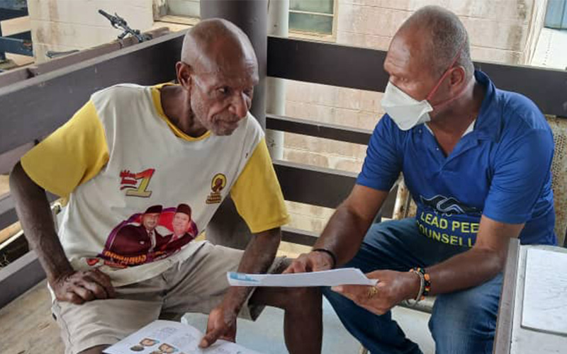Patient Maduwa Geawi with a healthcare worker in Daru, Papua New Guinea.